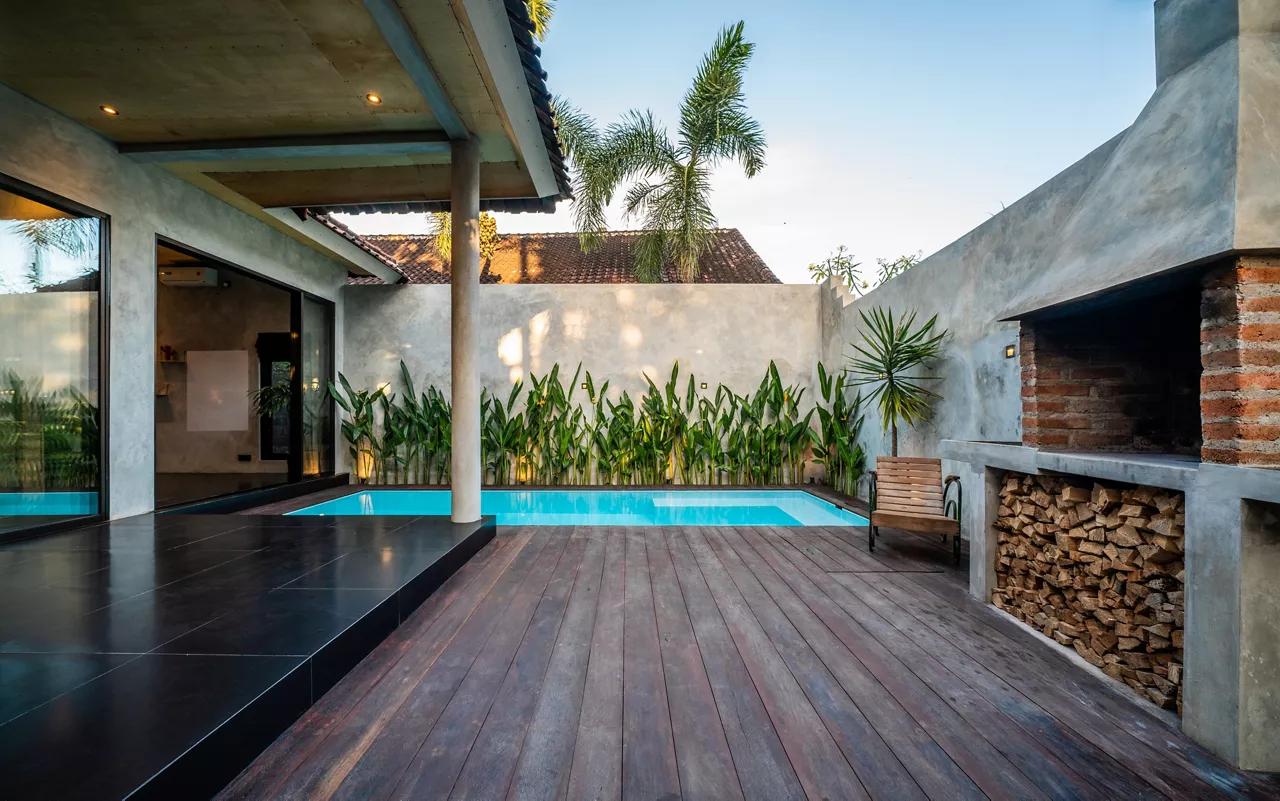 Grill area in the villa by the sea. A large courtyard with a stone grill and an open white stone kitchen.
