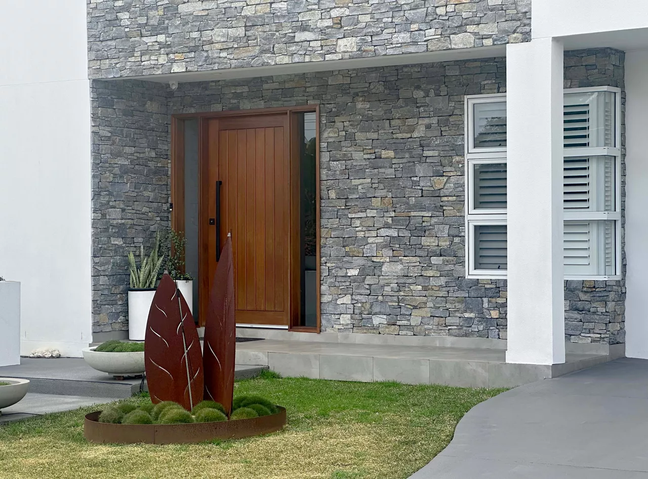 Front entrance of a grey stone clad modern home