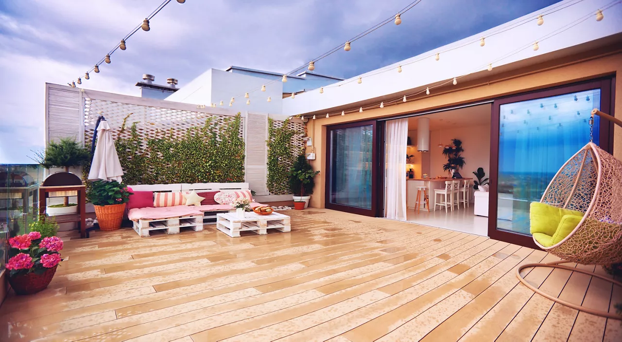 rooftop patio zone with sliding doors and open space kitchen at warm rainy day