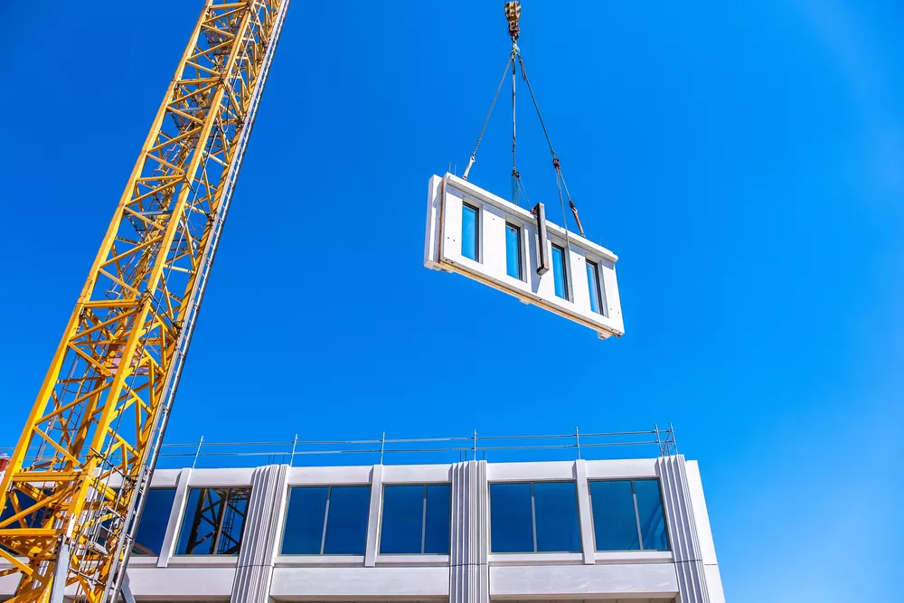 Crane lifting and moving a wall piece for brand new architecture in The Netherlands, Europe.