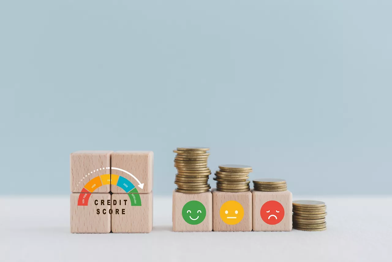 CREDIT SCORE text with indicator gauge meter on wooden cube block with stack of coin and emoticon including copy space