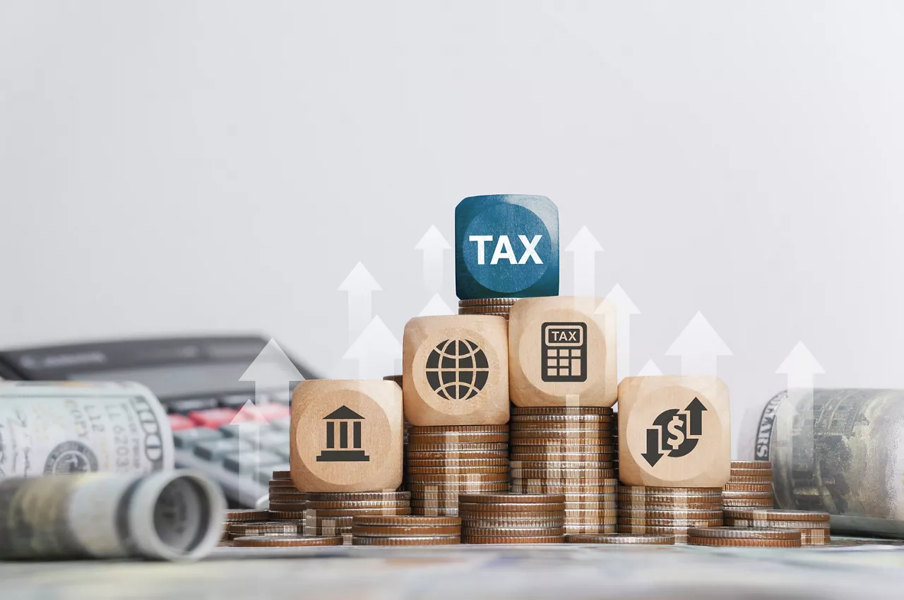 Tax concept with icons on wooden blocks Tax reduction planning, expenses, accounting, VAT and property taxes. Request a tax refund and submit taxes for online tax documents to the government.