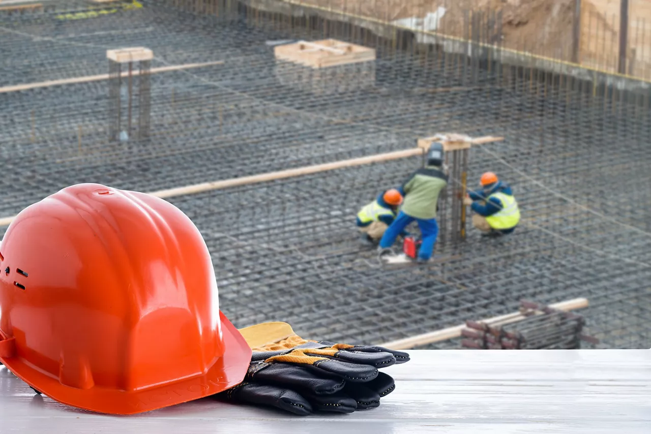 orange construction helmet on the background of building construction