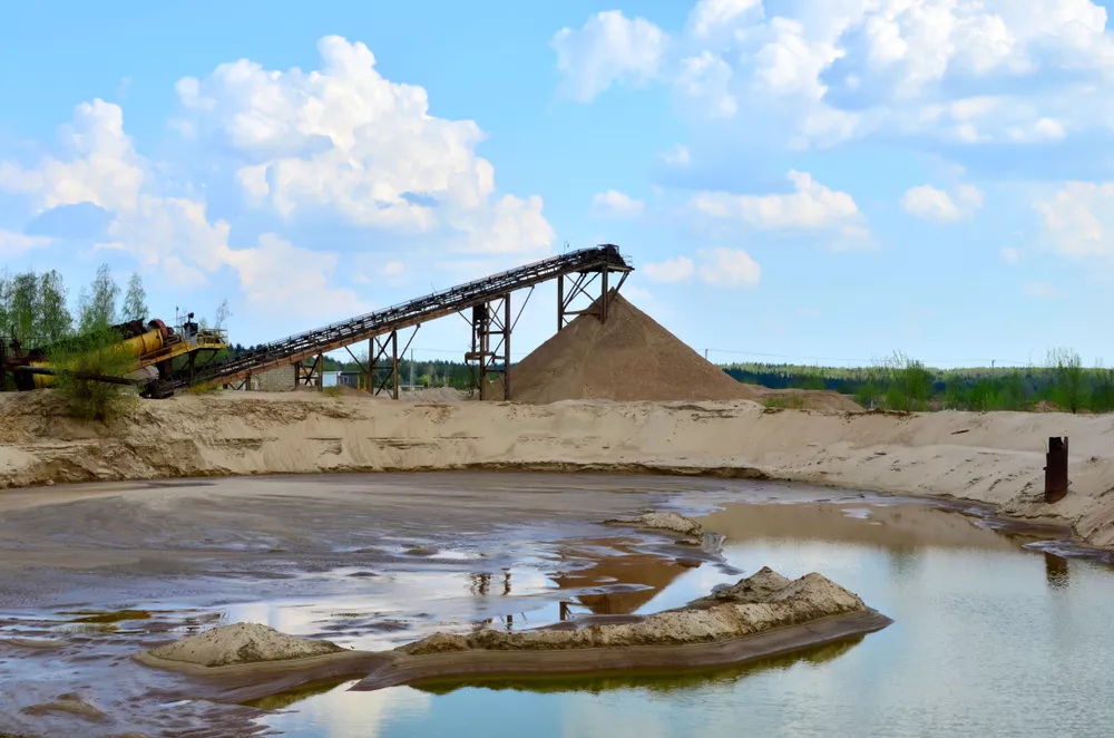 Sand Making Plant in mining quarry. Crushing factory, machines and equipment for crushing, grinding stone, sorting sand and bulk materials.
