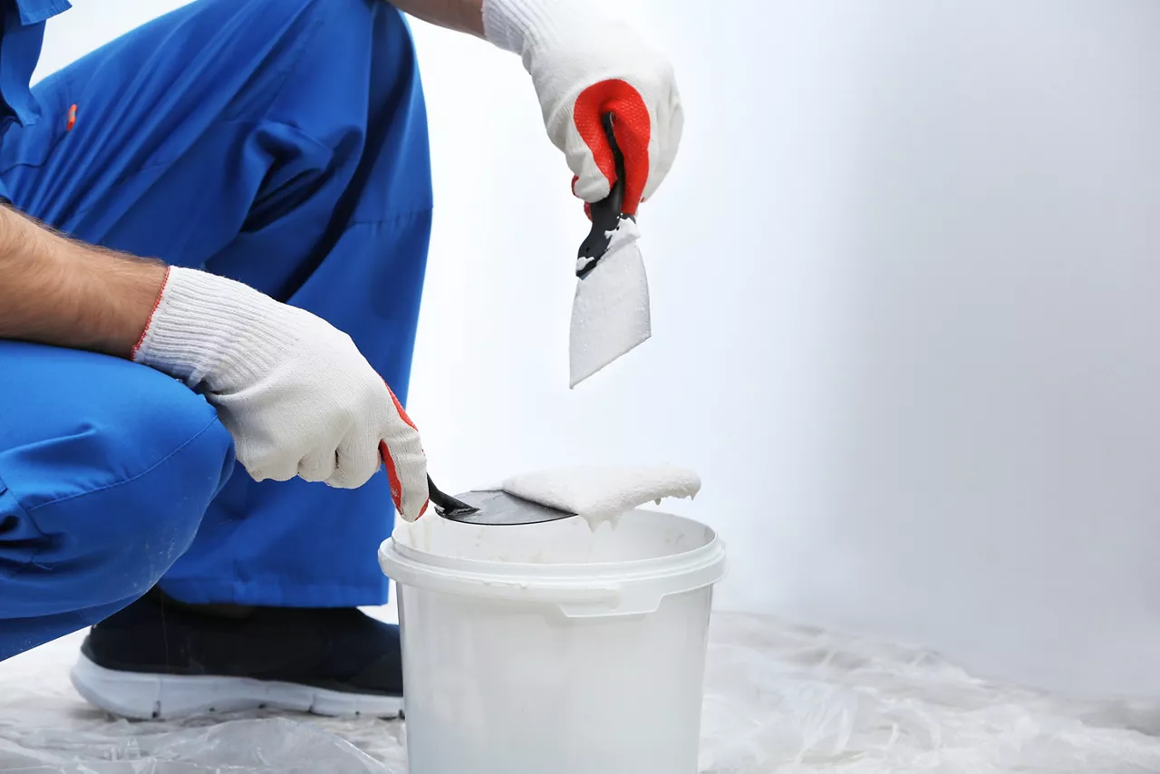 Professional worker making repair in room