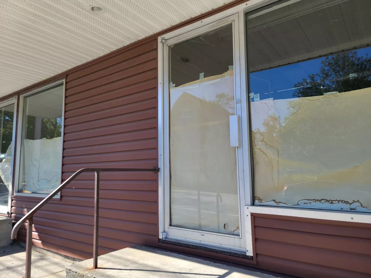 A large glass door with paper covering it from the inside.