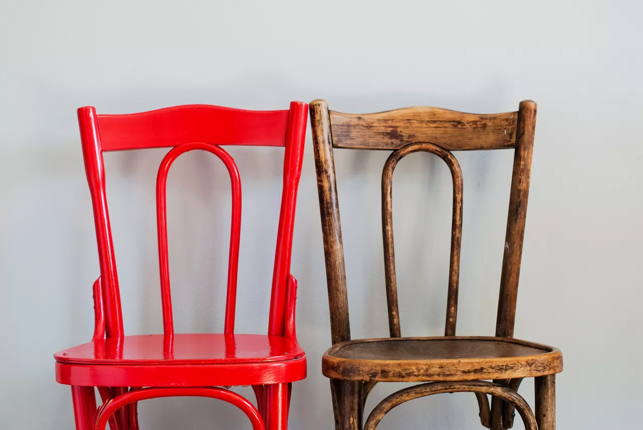 Pair of Red and Brown Chairs on a Grey Wall