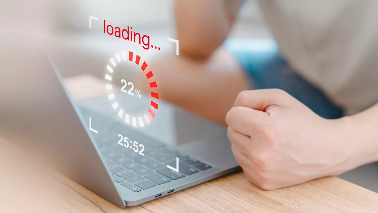 User use a laptop computer to download and update software with waiting to load digital file data from the website, and very slow internet from wifi. Concept of waiting for a load of loading symbol.