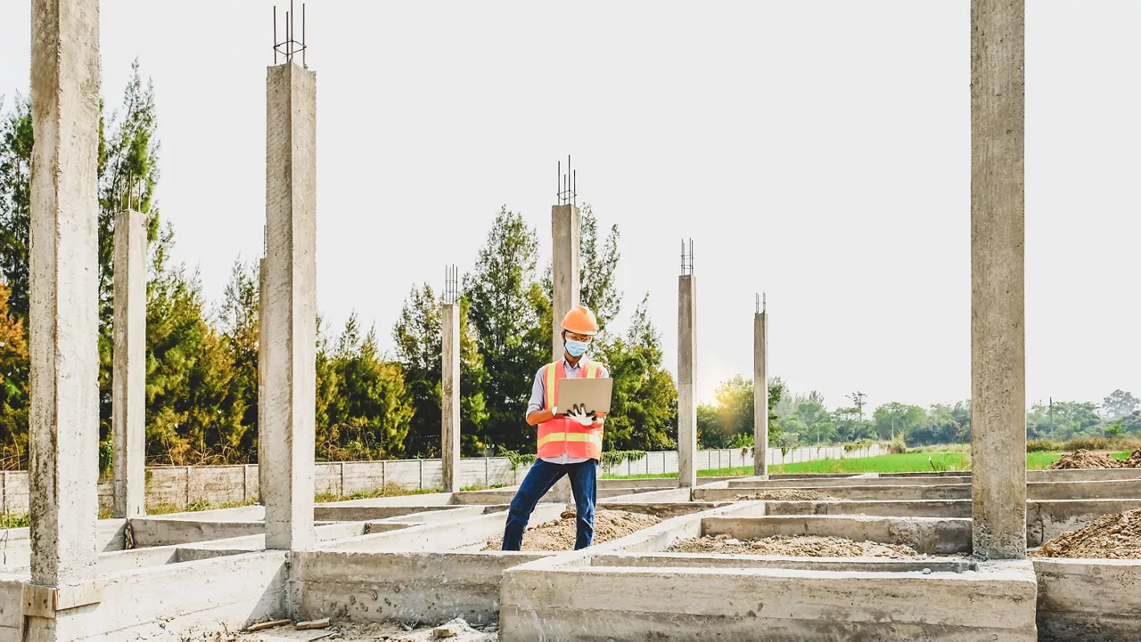 building construction structures site. Engineer contractor man uses laptop work safety industry project, check house plan design and investigating the size and quality.
