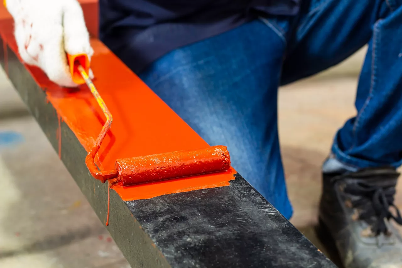 Rust-proof painted steel pipes in the factory. Red iron pipe. Rust-proof paint, water pipes