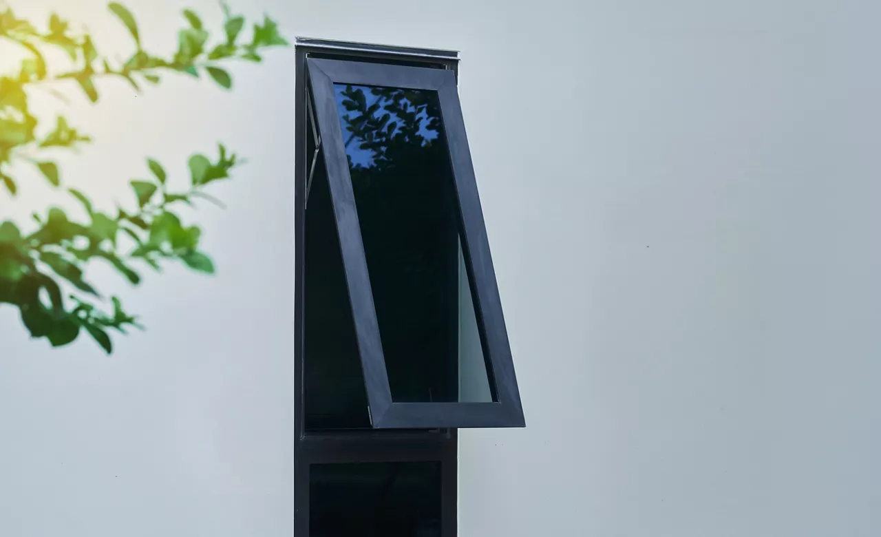 Black aluminum awning window frames on white wall