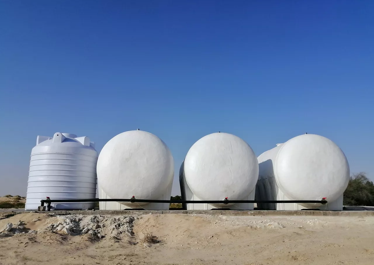 Huge water tanks installation in the middle of the desert of Al Muntanaza National Park, Al Ahsa Saudi Arabia for plants watering as reverse desertification project. 