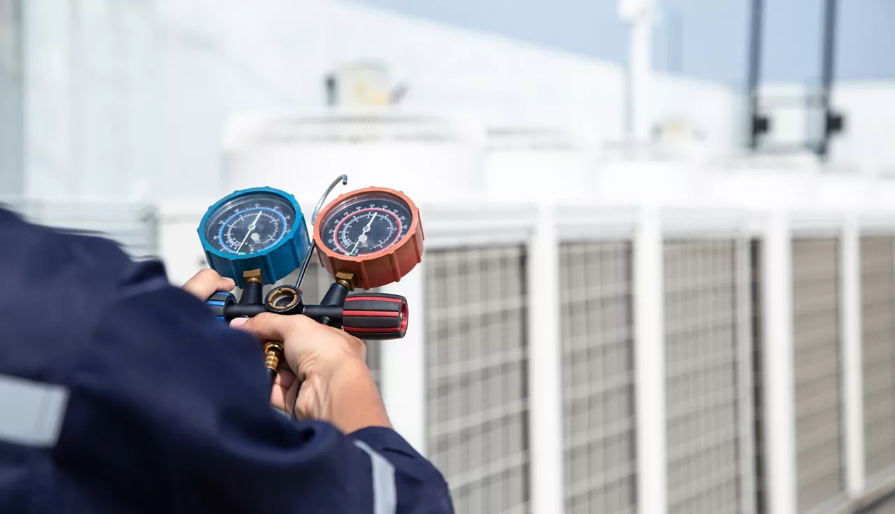 Technician is checking air conditioner ,measuring equipment for filling air conditioners , service and maintenance air conditioner .