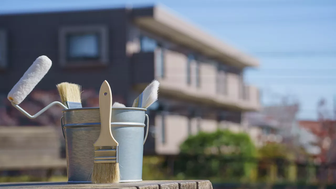 Painting tools and residential area.Image of roof and exterior painting.