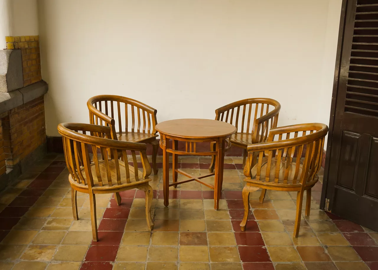 set of table and chairs made from wood at Lawang Sewu building photo taken in Semarang Indonesia