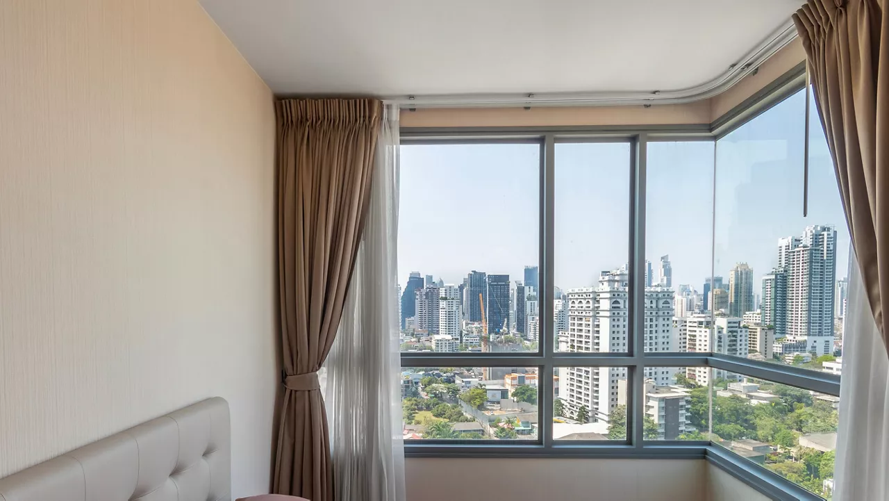Big window in the bedroom overlooks the skyscrapers.