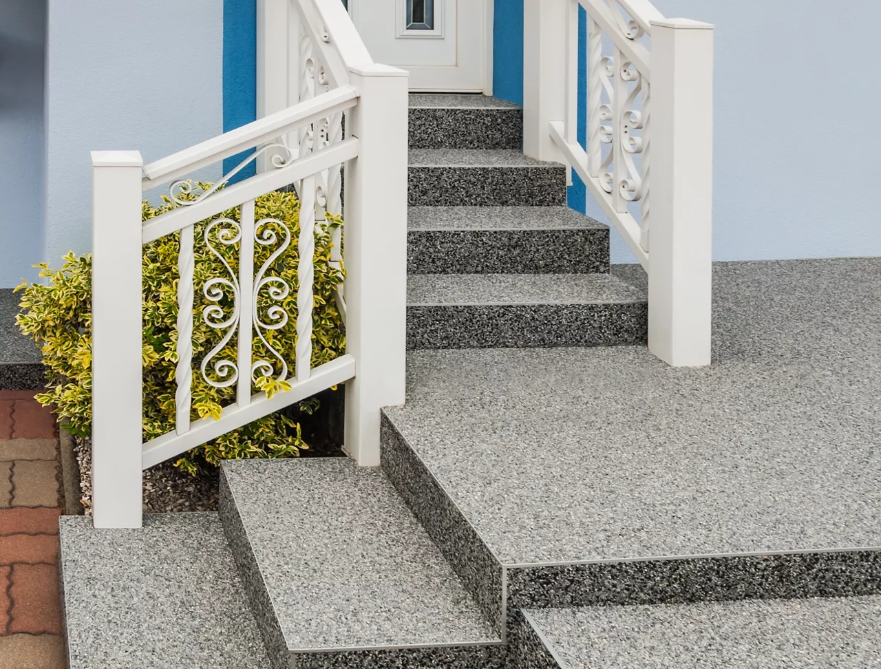 Modern outdoor staircase with stone carpet coating and white lacquered aluminium railing