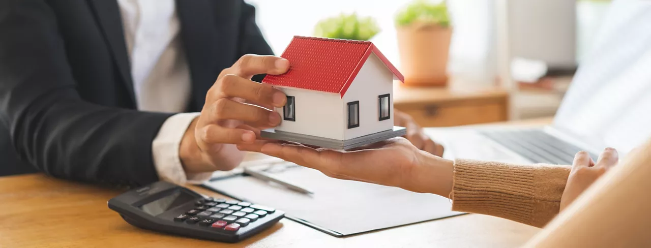 Real estate, banker present house model with client before tenant sign contract rental purchase buyer home with landlord, realtor after agreement mortgage success done. Property lease agent concept.