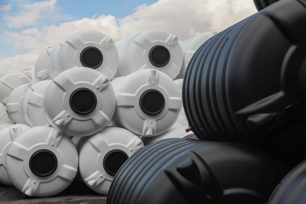 black and white water tanks, plastic PVC ,organized next to each other