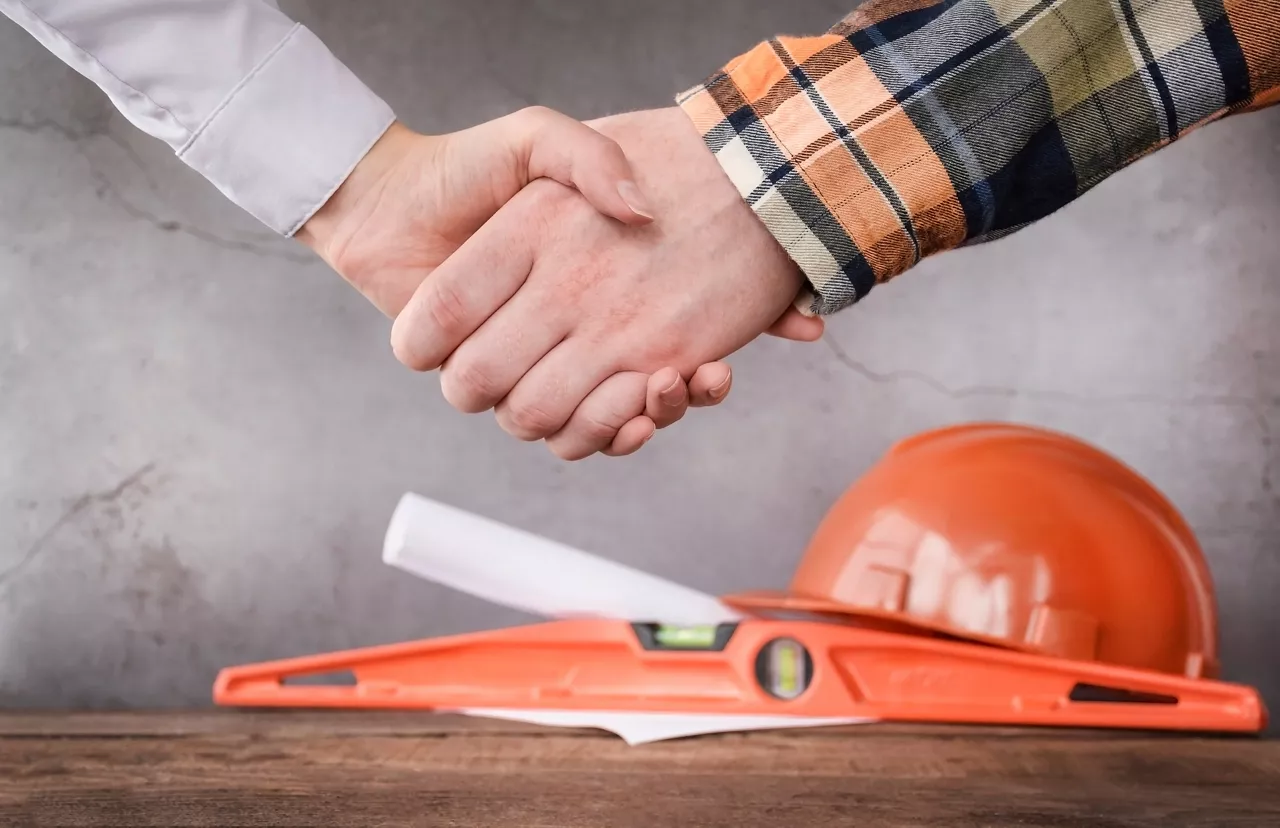 Handshake of businessman and builder