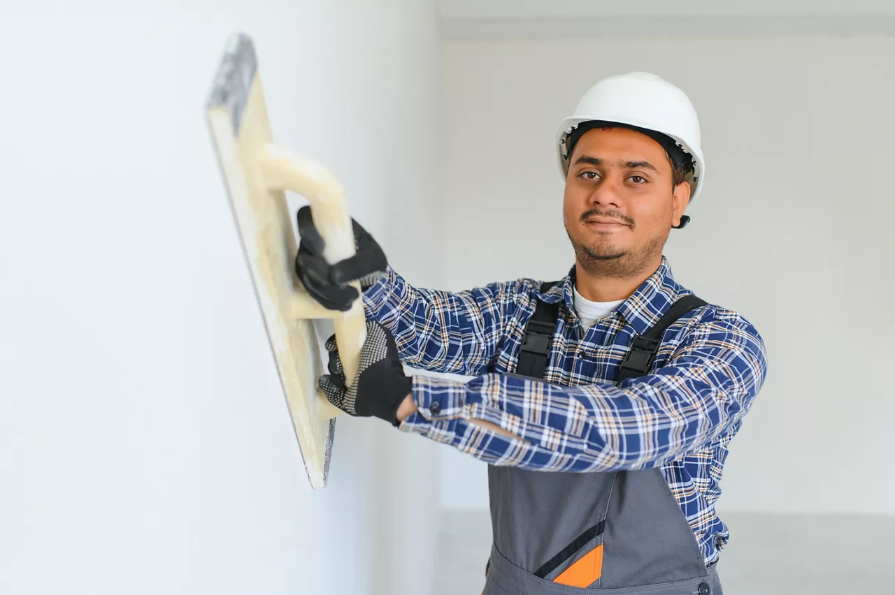 Worker make repairs in new apartment.