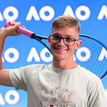 Anderson Parker poses with his tennis racquet
