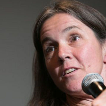 Anne Minter speaks at an event