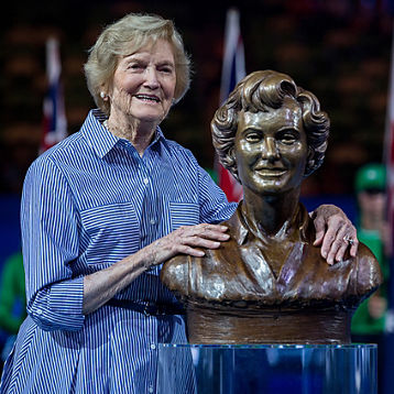 Beryl Penrose Collier poses with a statue