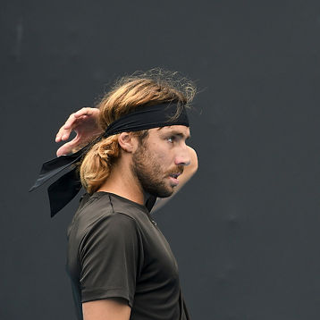 Calum Puttergill plays doubles tennis