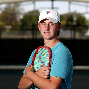 Cameron Burton poses with his tennis racquet