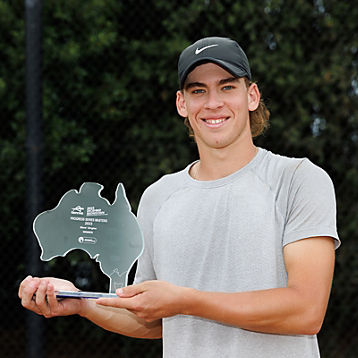 Casey Hoole holding a tennis award