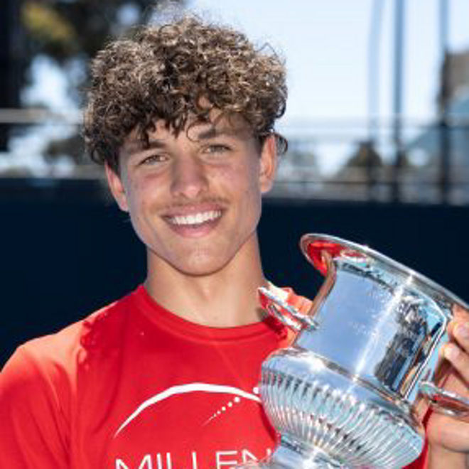 Daniel poses with a tennis trophy