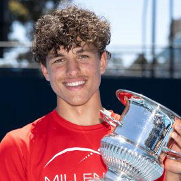 Daniel poses with a tennis trophy