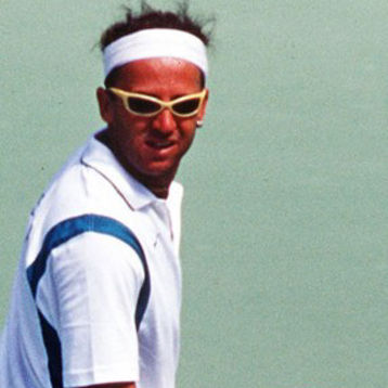 David Johnson playing tennis in sunglasses.