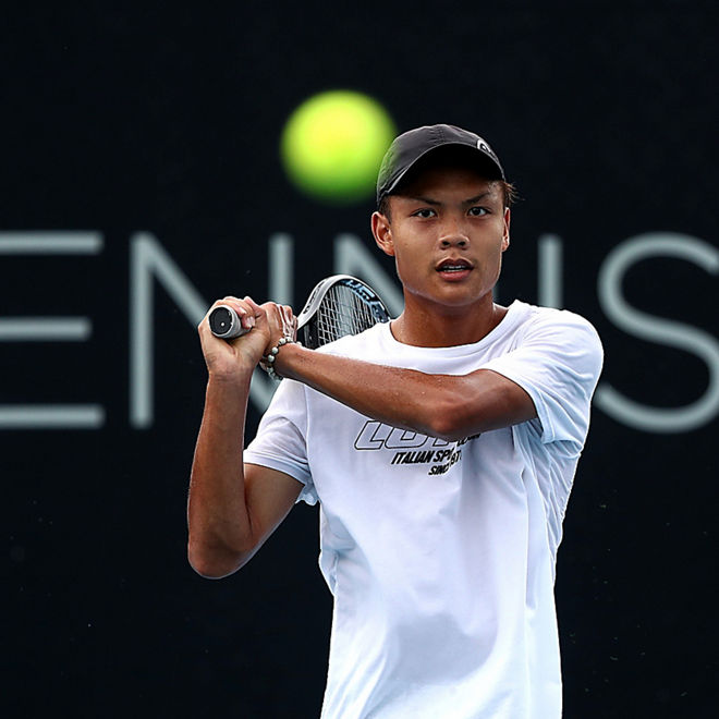 Derek Pkam hits and watches a tennis ball.