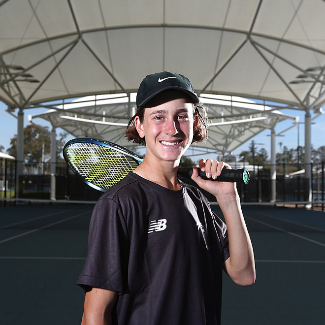 Elijah Dikkenberg poses with a tennis racquet