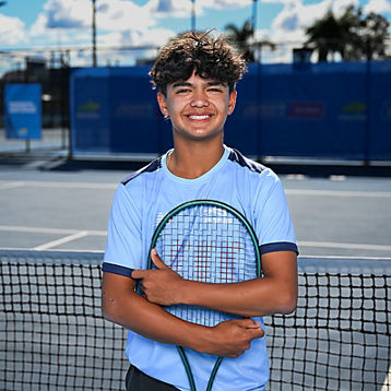 Ethan Domingo poses with his racquet on a tennis court