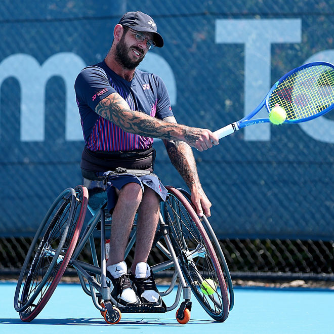 Heath Davidson plays a tennis shot