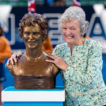 Jan Lehane Oneill poses with a statue