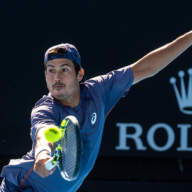 Jason Kubler stretches for a tennis shot