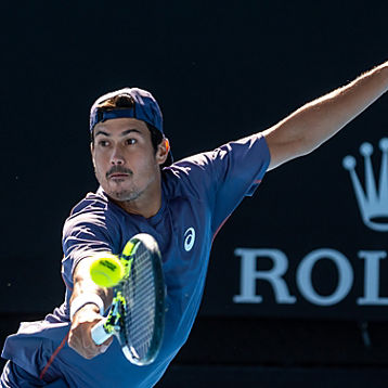 Jason Kubler stretches for a tennis shot