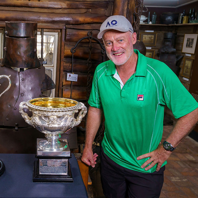 John Fitzgerald poses with tennis trophies