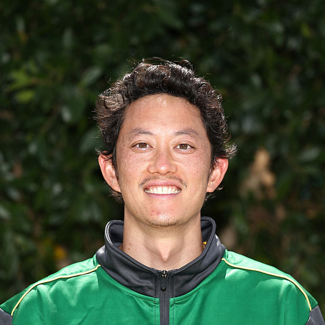 John Lui stands smiling
