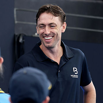John Millman smiles with some Ballkids