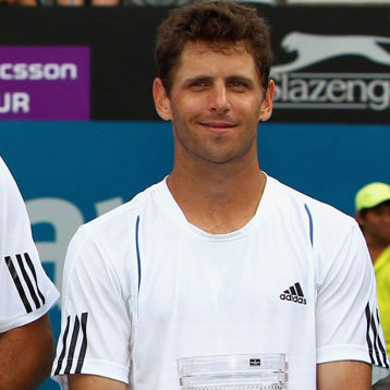 Jordan Kerr smiles holding a trophy