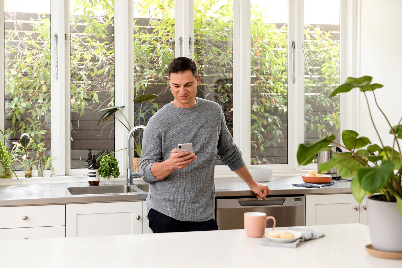 Man in kitchen on phone