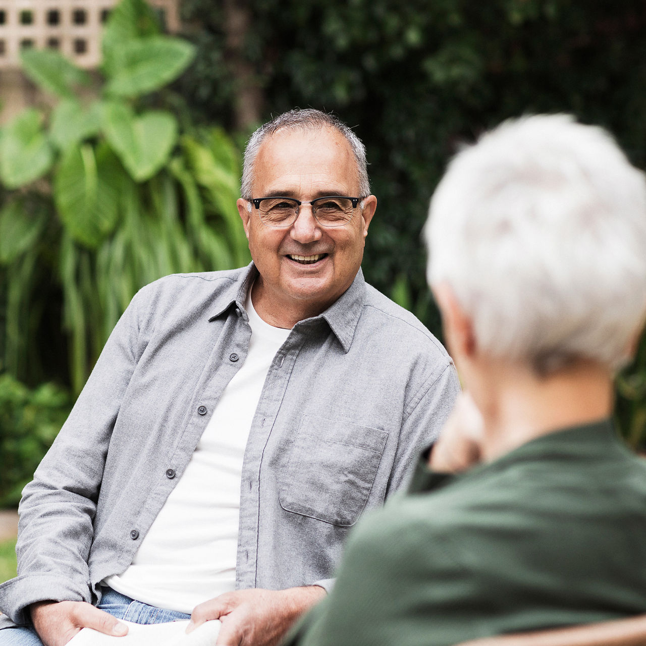 Senior man talking to woman in the garden