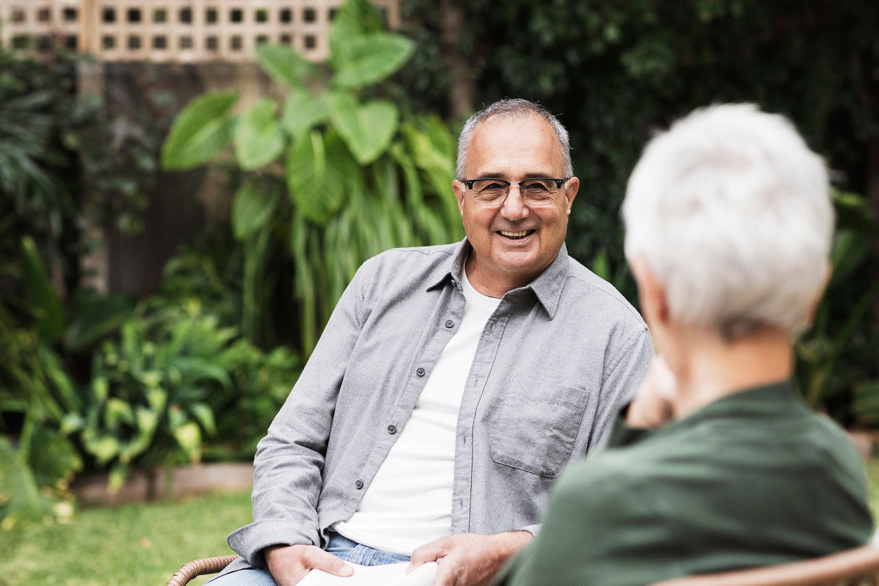 Senior man talking to woman in the garden