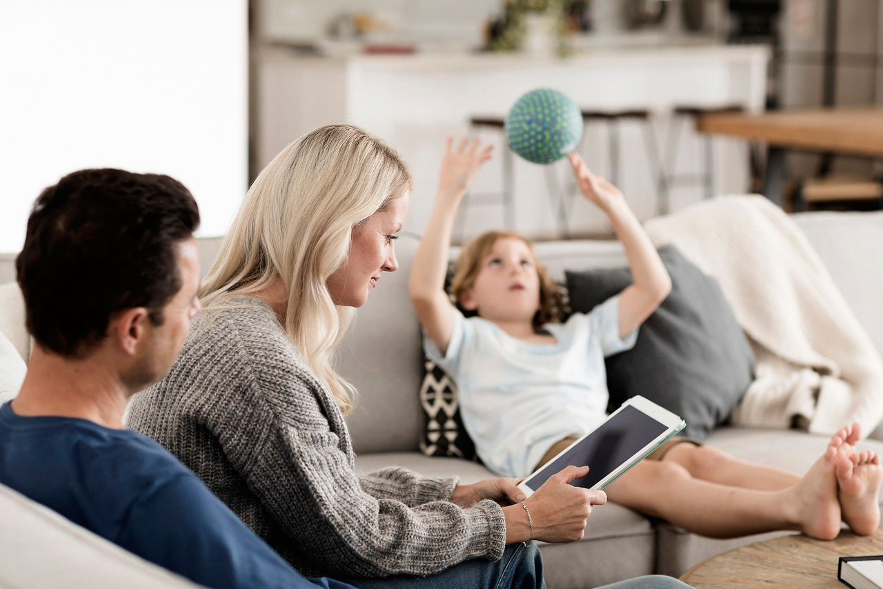 Family in the living room, sitting on the sofa