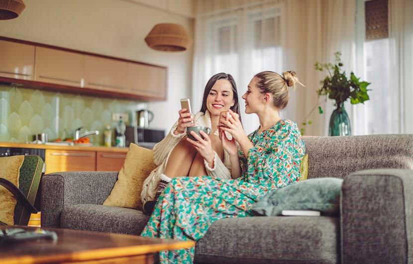 women talking on couch